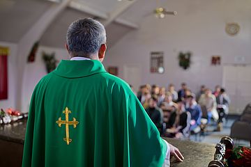 Priester vor Gemeinde